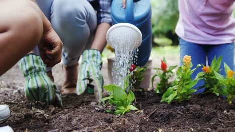 Mid-section-of-a-family-gardening-together