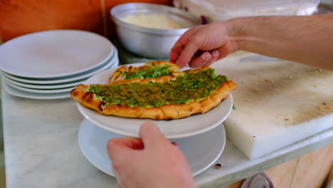 cheese is poured on the baked pita