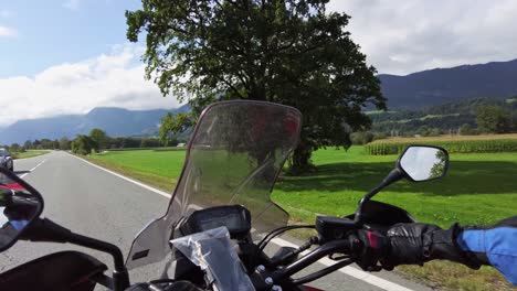 pov of biker rides a motorcycle on a scenic mountain road in austria