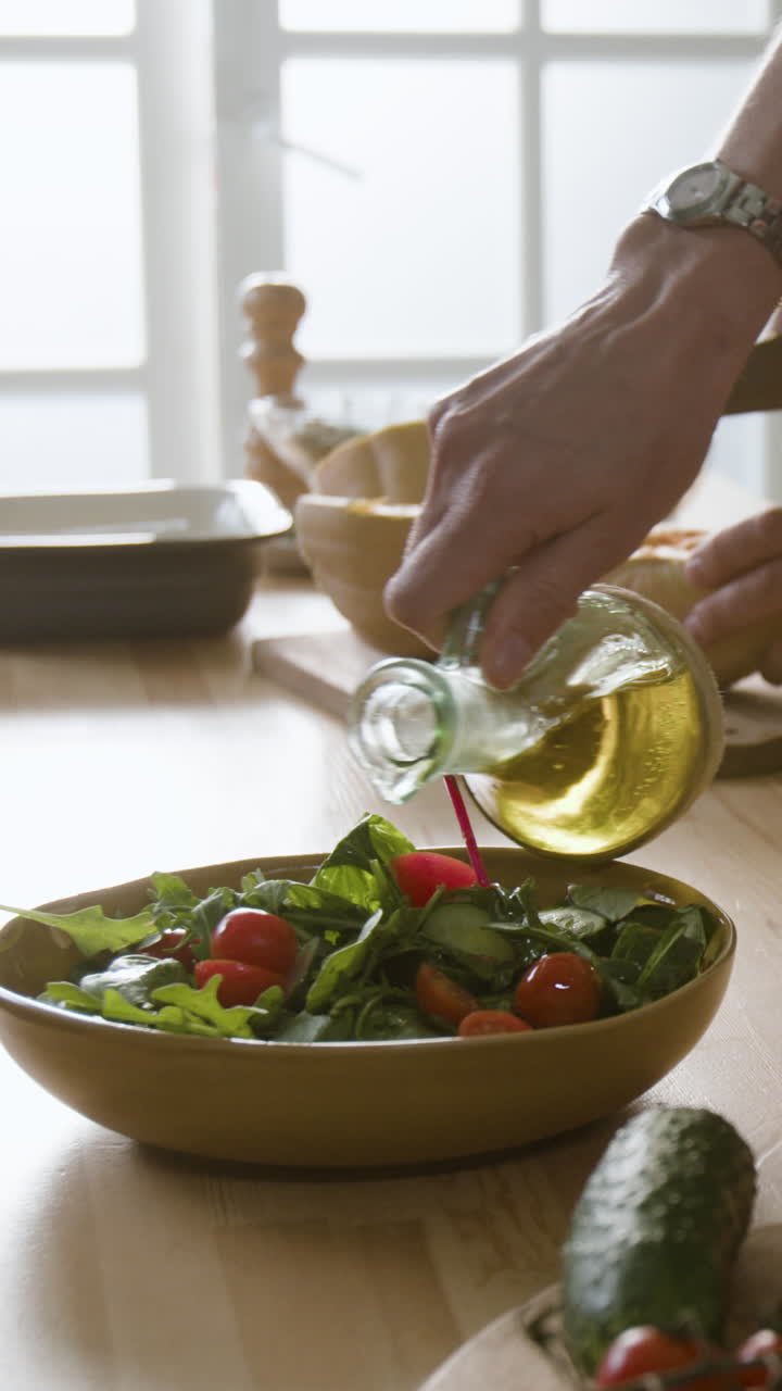 Preparing a fresh salad with olive oil