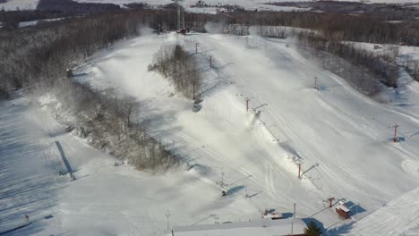 overhead drone view of snow being made on ski hill in wisconsin