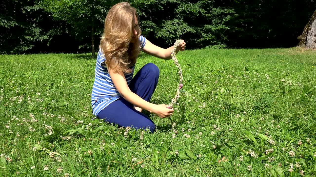 creative woman weave head crown circlet from clover flowers. 4K