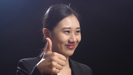 smiling businesswoman giving thumbs up
