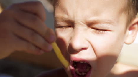 kid eating fries outdoor