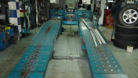 empty car repair shop with lift and equipment