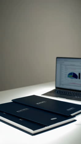 laptop with financial data and documents