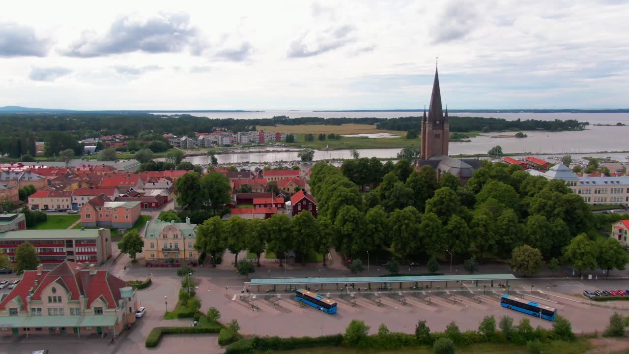 Scenic aerial view of the cathedral, green parkland, and red-roofed old town houses. Aerial bird's eye view