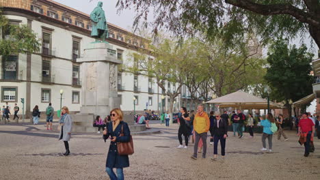 city square with statue and people