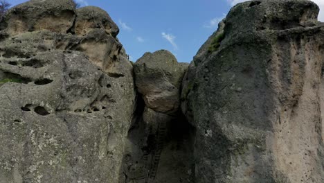 retreating drone shot of karadzhov kamak, a natural rock formation venerated by the ancient thracians as the place of the dead, located in plovdiv province in bulgaria