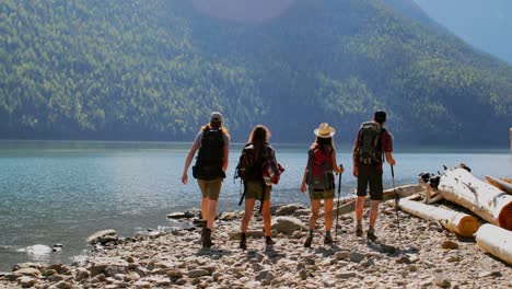 group of friends hiking near riverside 4k