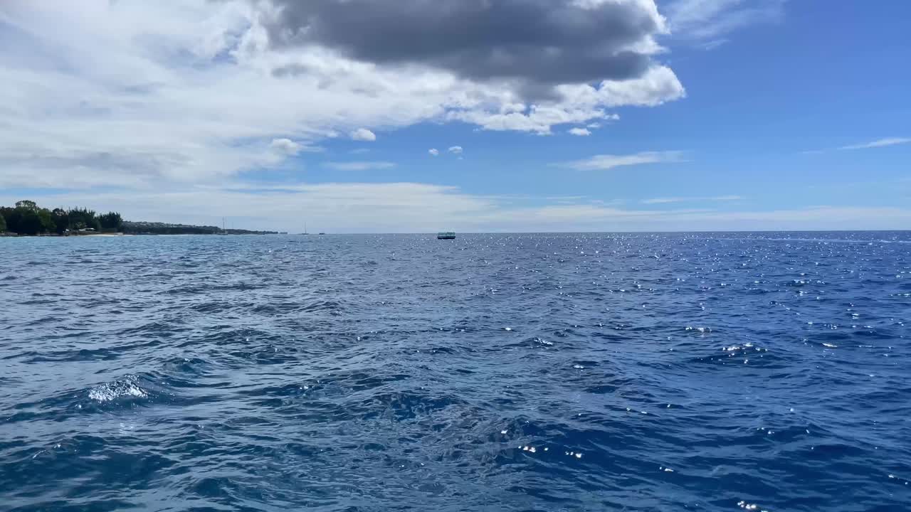 Sailing off the coast of Barbados a floating pier on the horizon, UHD