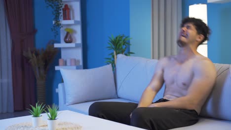 young man crying sad and unhappy at home at night.