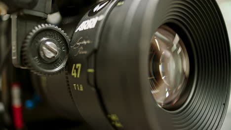 close-up of a focus motor on a professional cinema camera calibrating, turning the focus ring of a high end spherical prime lens