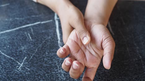 woman holding her wrist in pain