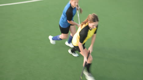 female hockey player preparing for action on field during competitive match