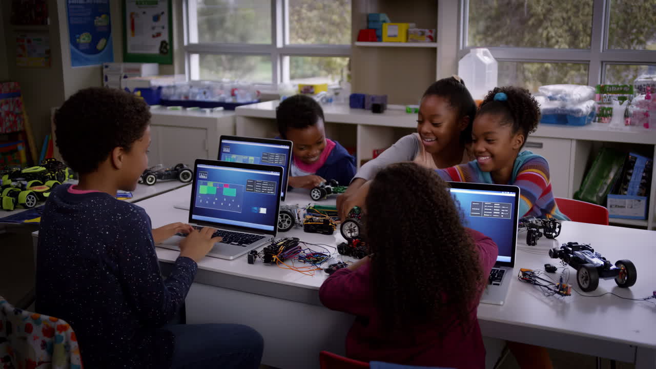 Children engaged in robotics and coding activities in a classroom