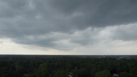 drone captures a black cloud above the sky just before it begins to rain