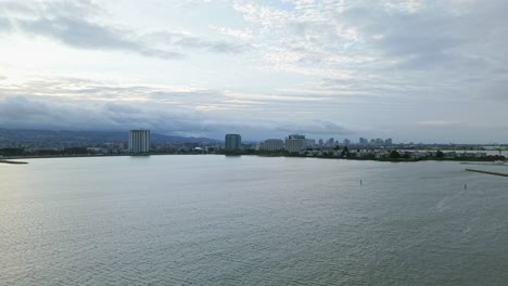 sweeping over emeryville's coastline, the drone highlights sparkling water meeting winding walking paths.