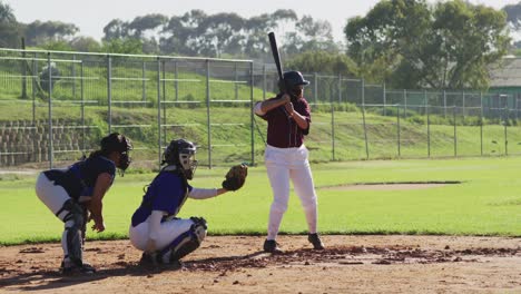 diverse group of female baseball players playing on the field, hitter swinging for pitched ball