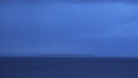 A-lighthouse-beams-a-light-out-from-a-very-remote-and-distant-island