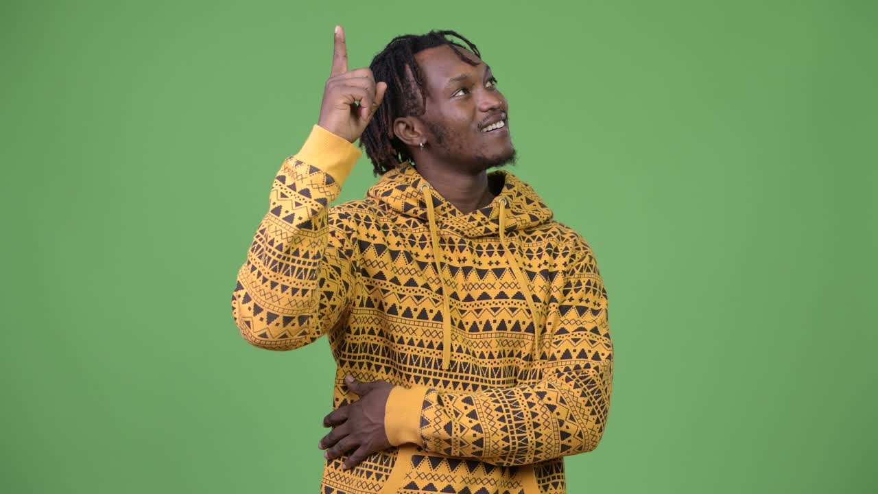 Young handsome African man thinking while pointing up