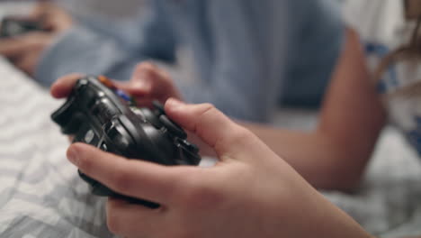 girl hand holding game joystick. gamer press buttons on gamepad