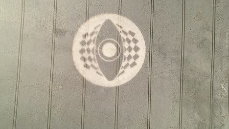 Aerial-view-descending-over-West-Meon-crop-circle-pattern-on-golden-agricultural-Hampshire-farmland