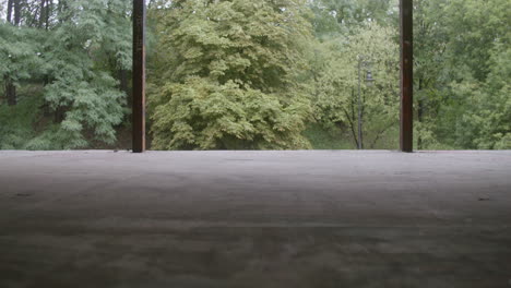 caucasian boy skateboarding in a ruined building.