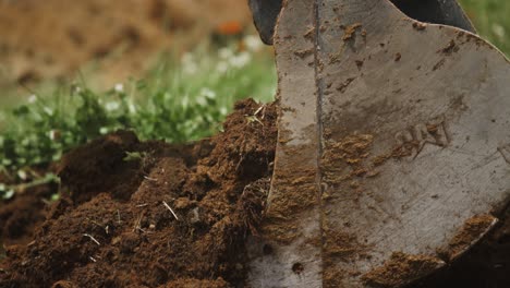 amazing slow motion macro shot of excavator digging through soil