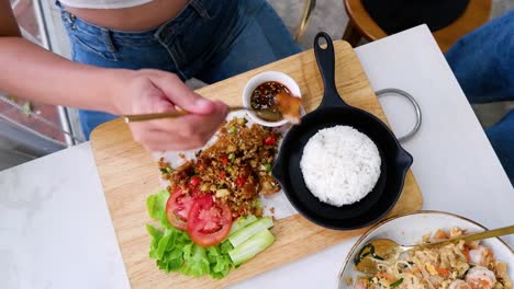 person preparing and eating crispy pork dish