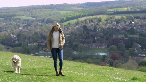 mature woman taking dog for walk in countryside shot on r3d