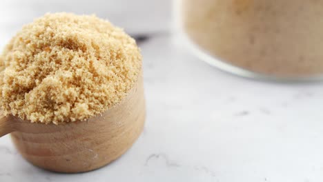 Coconut-sugar-in-a-white-bowl-on-table-,