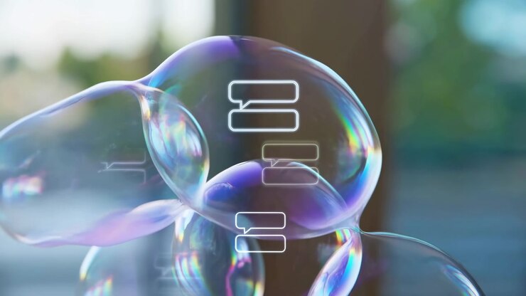 Rounded transparent forms deform and drift through close composition, reflecting rainbow highlights as white outlined speech bubbles slide across layered surfaces in soft daylight.