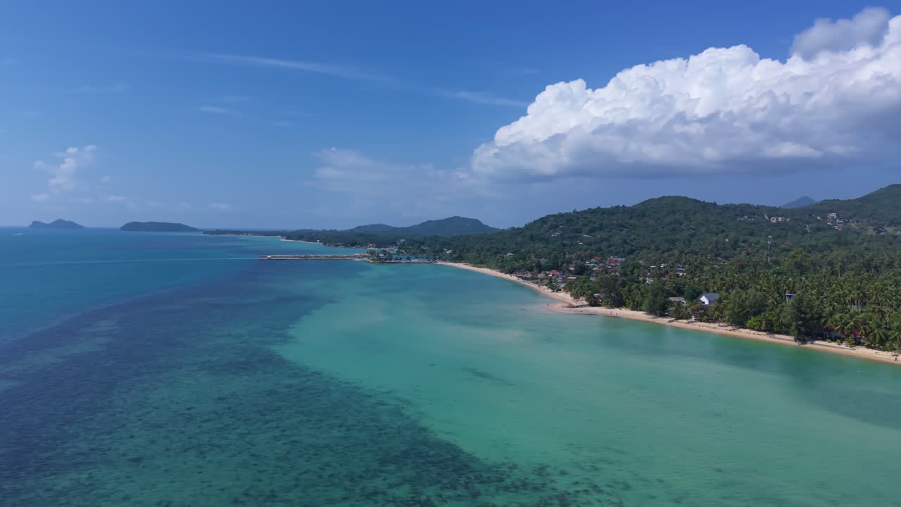 Cinematic panoramic view of tropical bay with shallow reef formations near shore