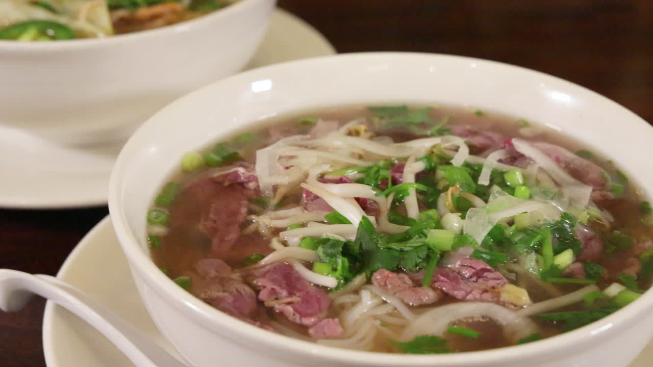 Two Large Bowls Of Asian Noodle Soups, Huge Servings Of Vietnamese Pho