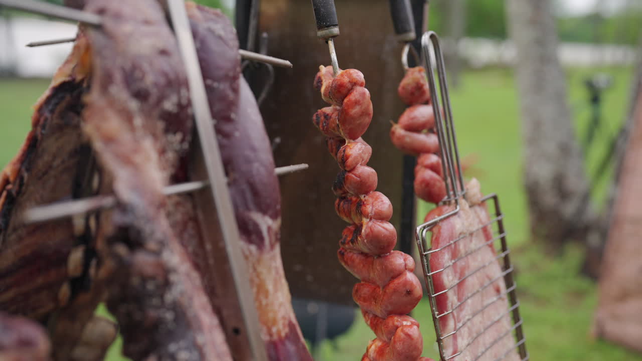 Traditional Argentine asado barbecue with meat cooking on a grill. Authentic South American outdoor cooking technique featuring premium beef cuts being grilled over charcoal flames