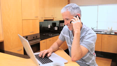 Smiling-man-using-his-cellphone