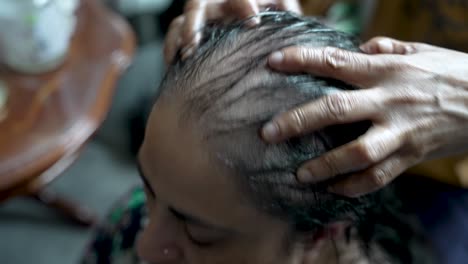 Overhead-View-Of-person's-hand-running-through-thinning-gray-hair-massaging-scalp