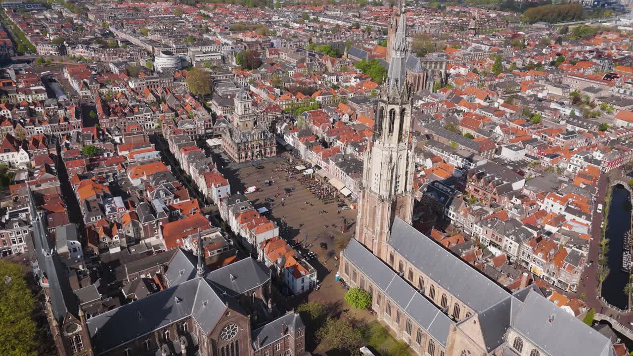 Stunning aerial view of Delft’s historic heart, featuring the imposing Nieuwe Kerk and the traditional City Hall overlooking the bustling city square.
