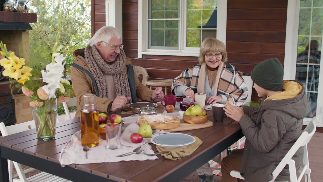 Family enjoying tea and pie outdoors