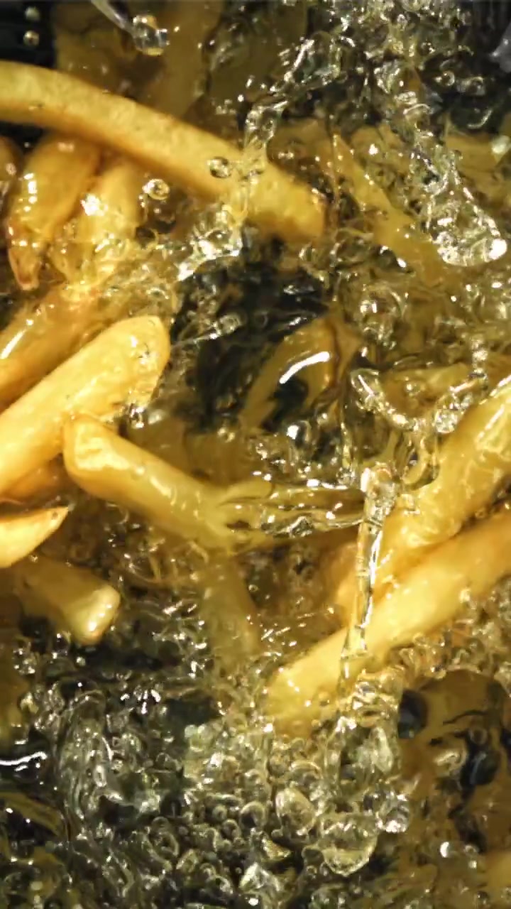 Close-up of Golden French Fries Deep Frying in Hot Oil
