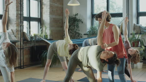 group yoga class with instructor assistance