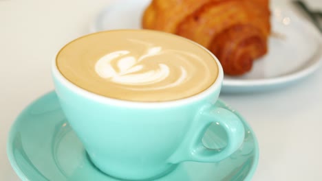 A-cup-of-late-coffee-with-flower-shape-design-on-top-at-cafe