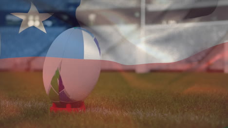 animation of chilean flag waving over rugby ball lying on a pitch digital composition