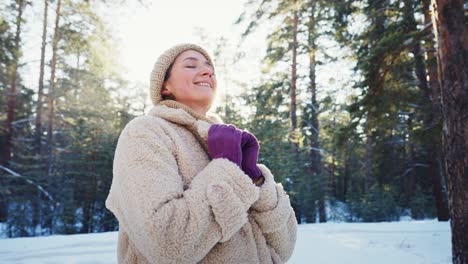 woman enjoying a winter day in the forest