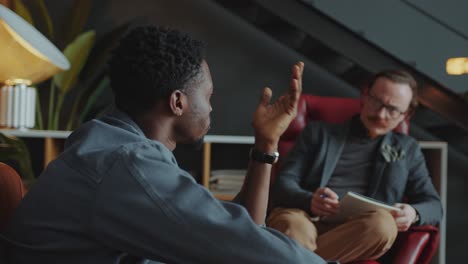 black man having individual counseling session with therapist in his office