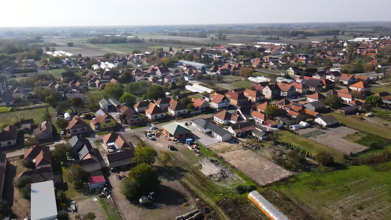 Aerial view of small town residential area surrounded by fields and countryside