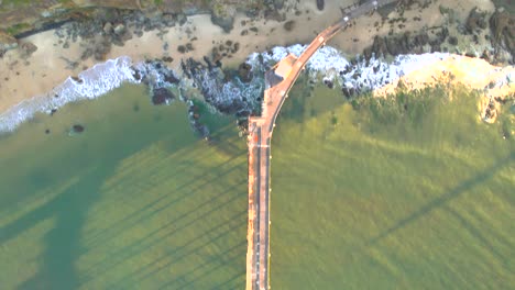 birds eye pov sunset shot of a ocean jetty, 4k 30fps