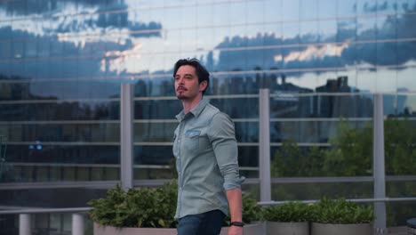 portrait of a handsome man in a denim shirt in an urban city setting