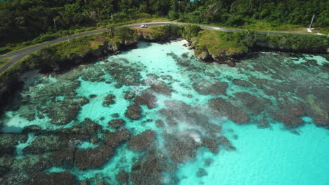 Slow-aerial-push-in-towards-wonderful-turquoise-coastline-in-Loyalty-islands,-New-Caledonia